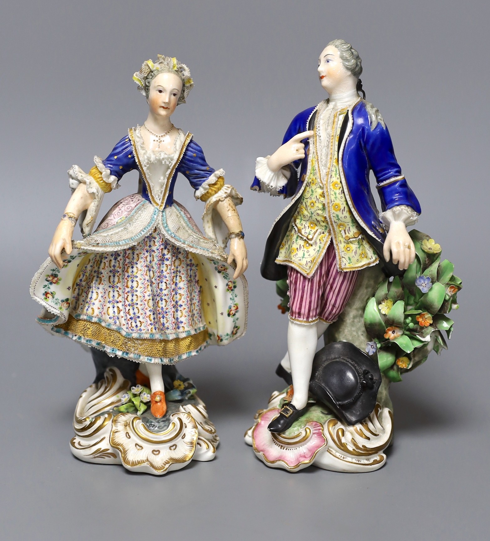 A pair of Derby figures of dancers, both elegantly dressed, incised N317 and blue crossed swords mark to base, tallest 19cm